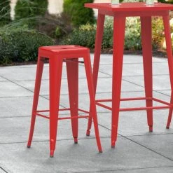 LT&S Alloy Series Lancaster Table & Seating Alloy Series Red Stackable Metal Indoor / Outdoor Industrial Barstool With Drain Hole Seat