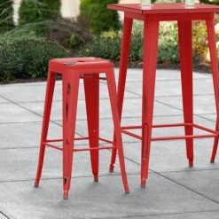 LT&S Alloy Series Lancaster Table & Seating Alloy Series Distressed Red Stackable Metal Indoor / Outdoor Industrial Barstool With Drain Hole Seat