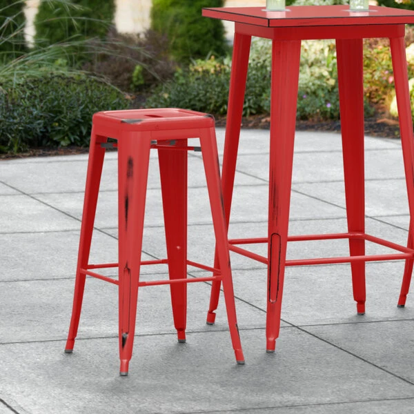 LT&S Alloy Series Lancaster Table & Seating Alloy Series Distressed Red Stackable Metal Indoor / Outdoor Industrial Barstool With Drain Hole Seat 1 LT&S Alloy Series Lancaster Table & Seating Alloy Series Distressed Red Stackable Metal Indoor / Outdoor Industrial Barstool With Drain Hole Seat